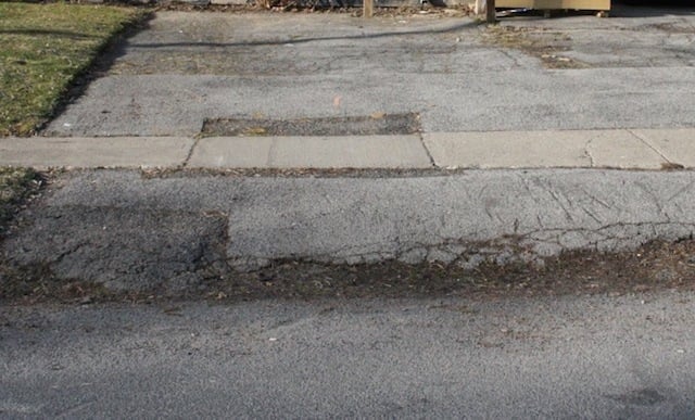 cracked driveway sidewalk></p><p> Image credit <a href=